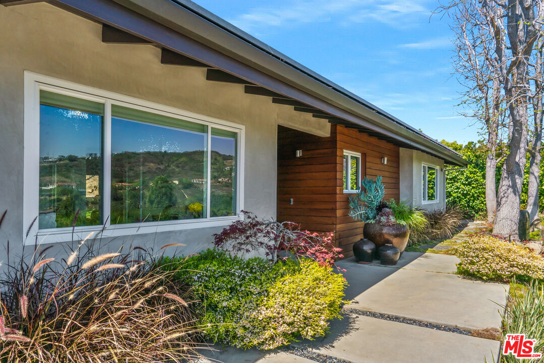 2137 Banyan Drive Los Angeles, CA 90049 - Photo 5 of 39 a front view of a house with a garden