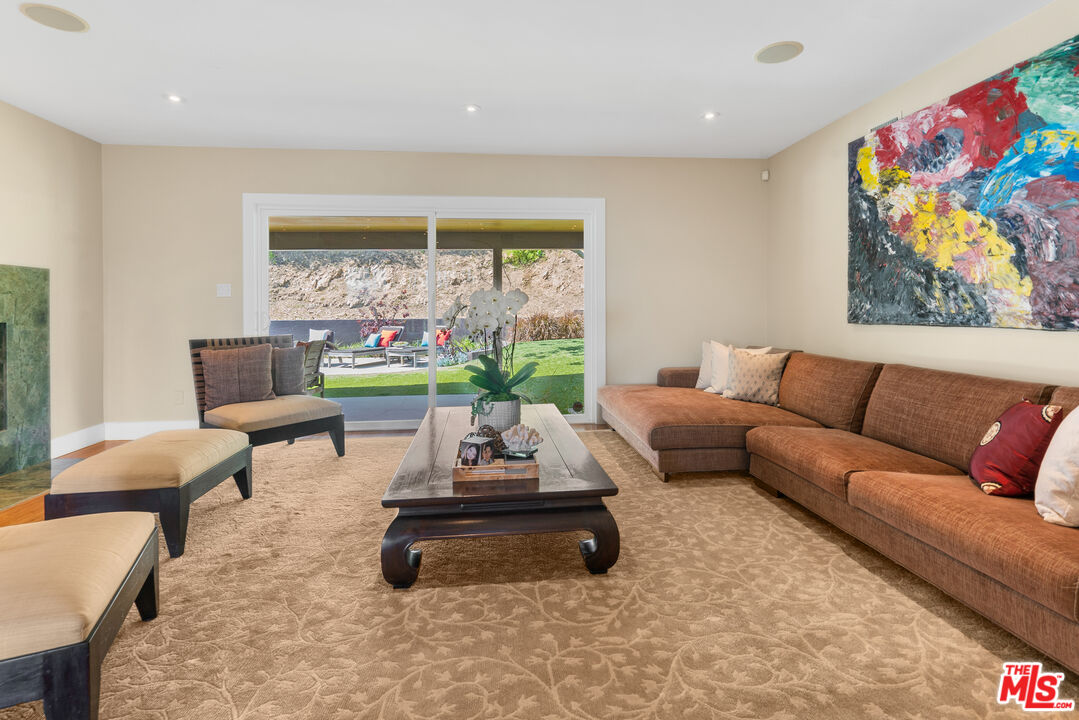 2137 Banyan Drive Los Angeles, CA 90049 - Photo 9 of 39 a living room with furniture and a floor to ceiling window