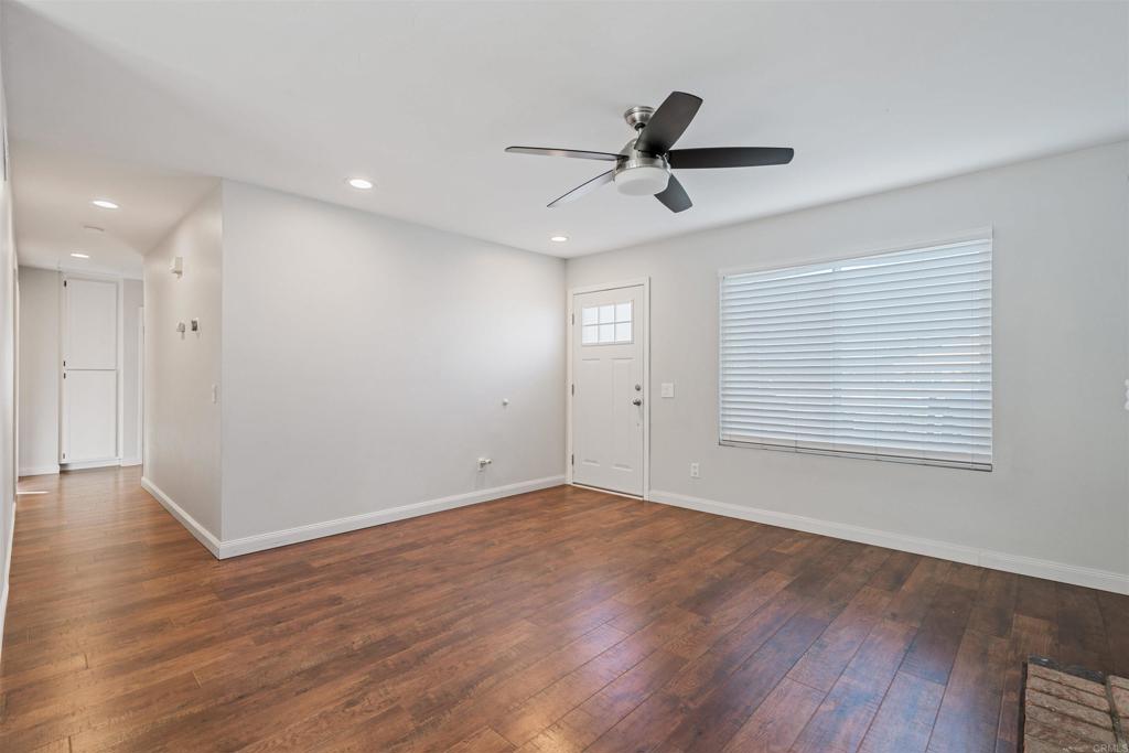 4435 Springtime Drive Oceanside, CA 92056 - Photo 12 of 22 a view of an empty room with wooden floor and a window