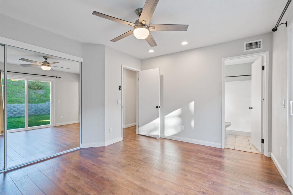 4435 Springtime Drive Oceanside, CA 92056 - Photo 14 of 22 a view of an empty room with window wooden floor and a ceiling fan