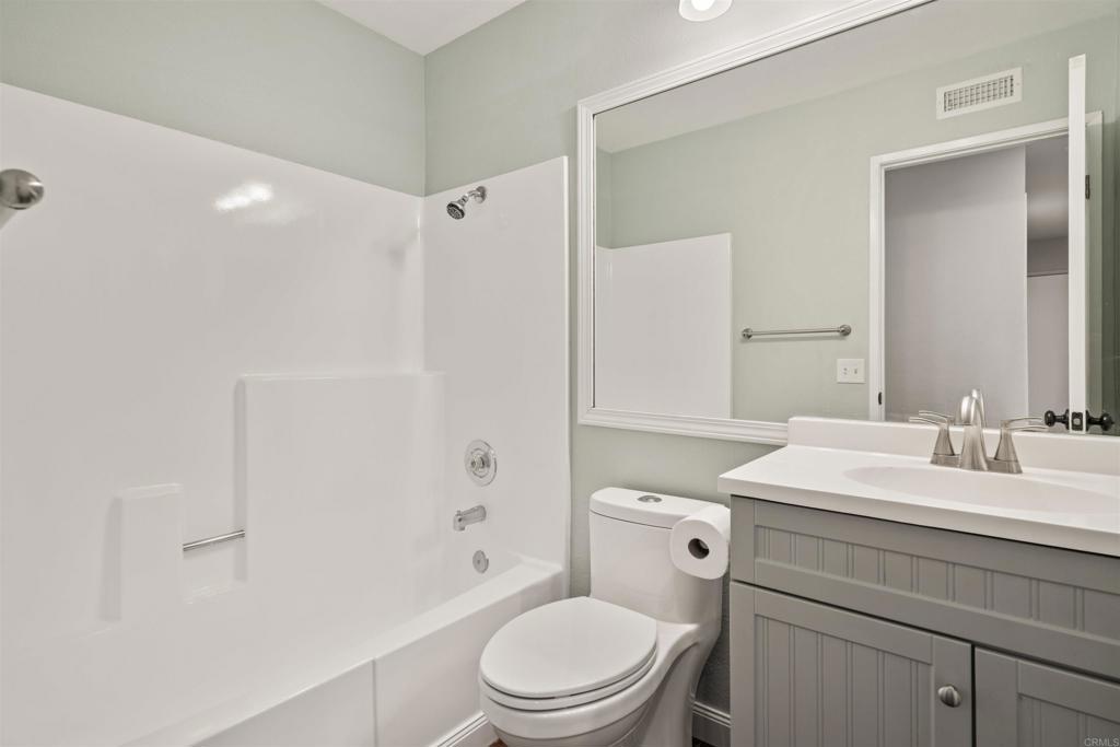 4435 Springtime Drive Oceanside, CA 92056 - Photo 15 of 22 a bathroom with a sink a toilet and shower
