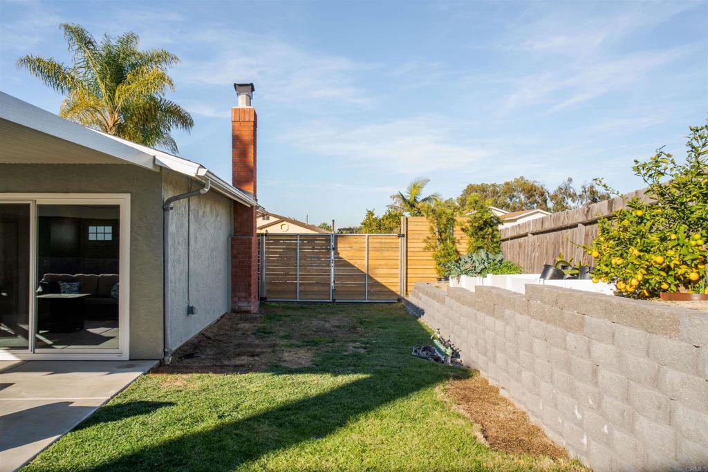 4435 Springtime Drive Oceanside, CA 92056 - Photo 18 of 22 a front view of a house with a yard and garage