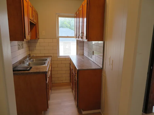 a kitchen with a sink and a refrigerator