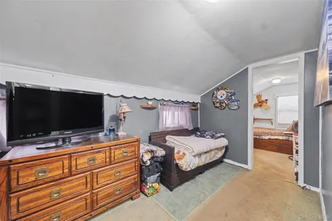 a bedroom with bed and flat screen tv