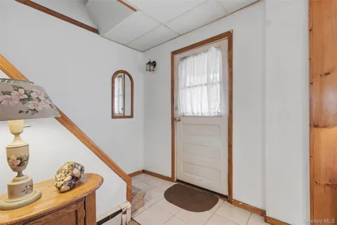 a front view of a house with entryway and wooden floor