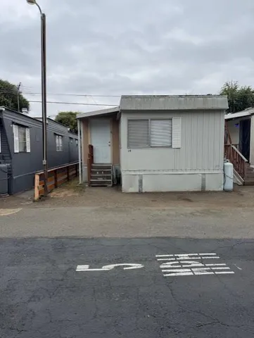 a view of a car park in front of house