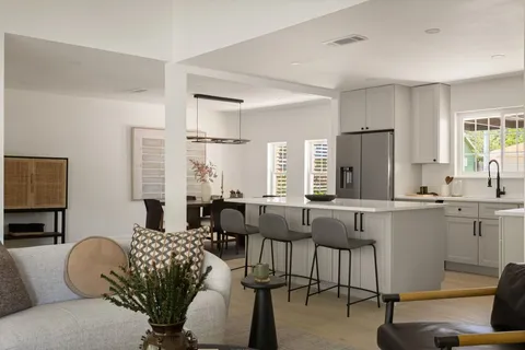 a living room with furniture windows and a table