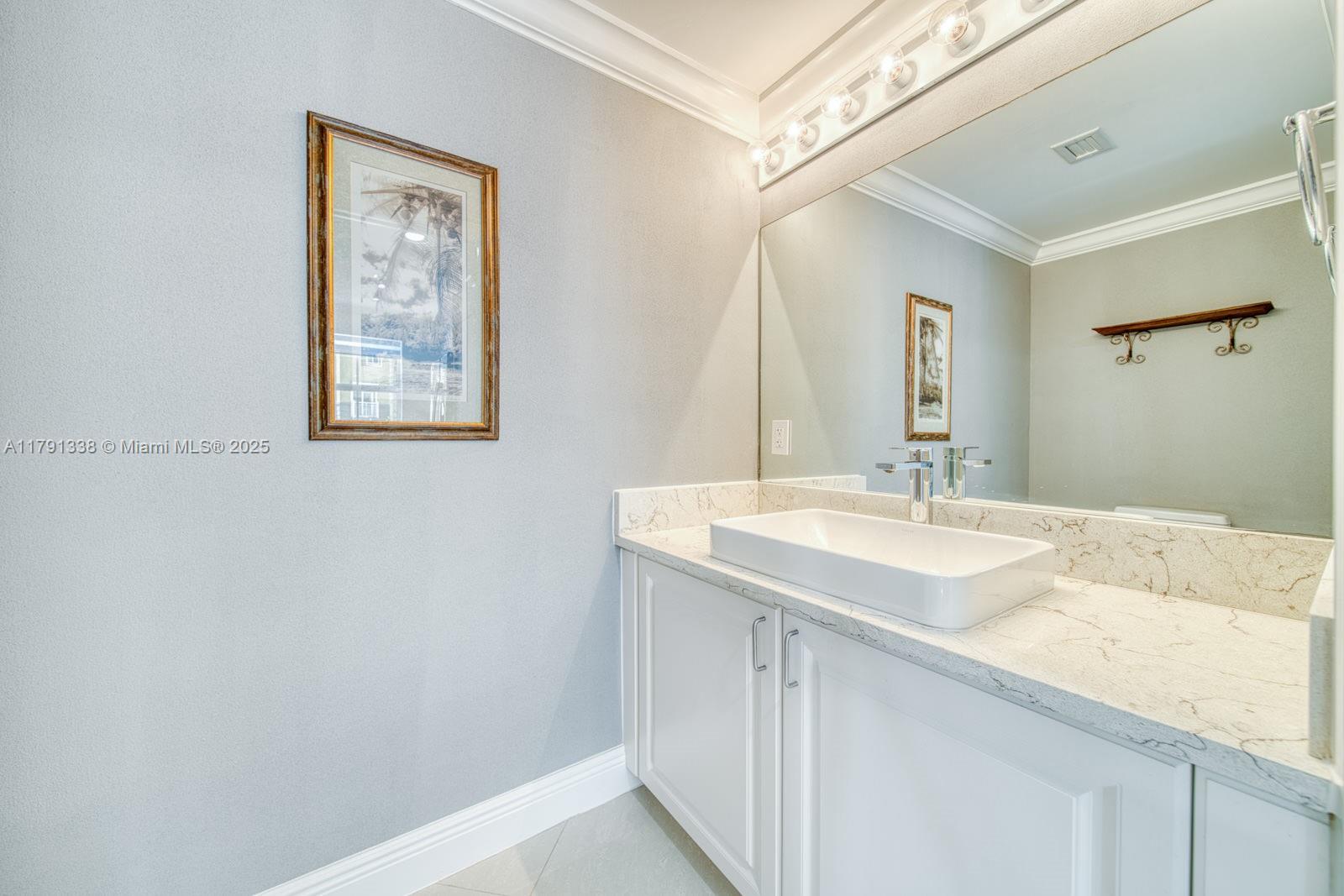 90 Alton Road, Unit TH2 Miami Beach, FL 33139 - Photo 12 of 32 a bathroom with a sink and a mirror