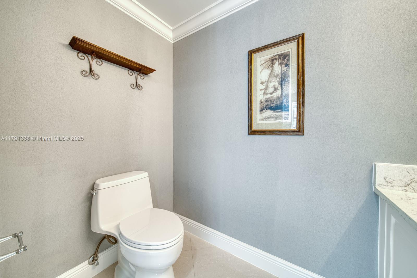 90 Alton Road, Unit TH2 Miami Beach, FL 33139 - Photo 13 of 32 a white toilet sitting next to a bathroom sink