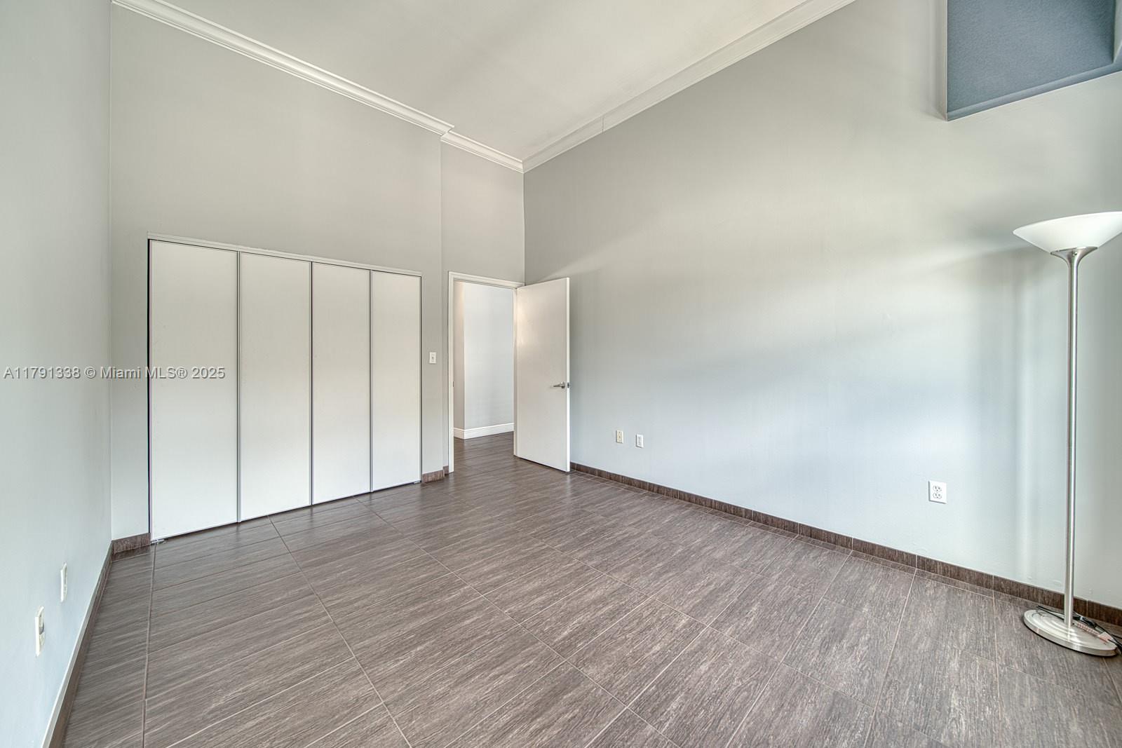 90 Alton Road, Unit TH2 Miami Beach, FL 33139 - Photo 17 of 32 a view of an empty room with wooden floor