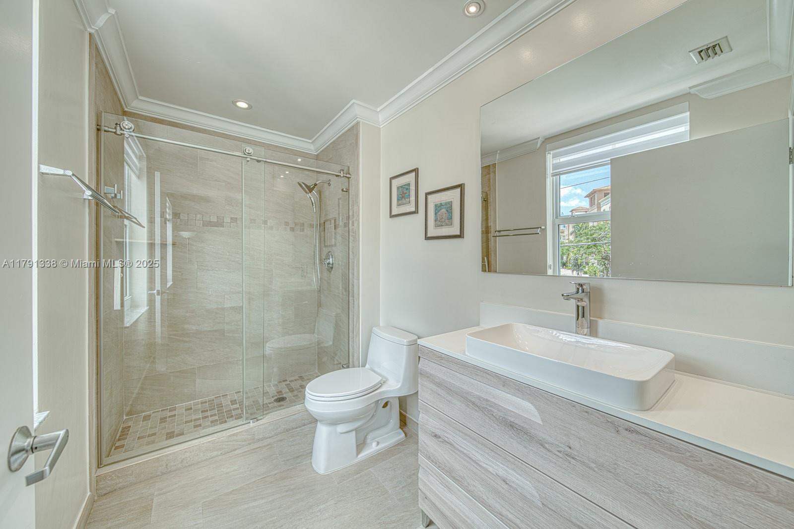 90 Alton Road, Unit TH2 Miami Beach, FL 33139 - Photo 18 of 32 a bathroom with a sink a toilet and shower