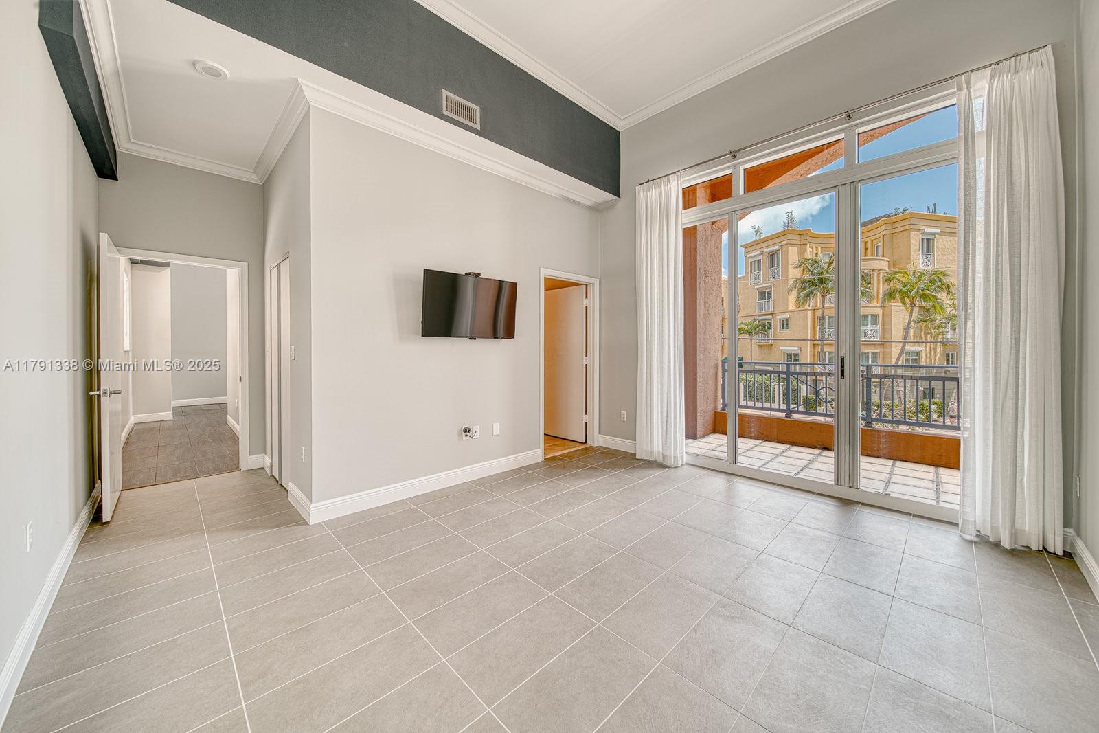 90 Alton Road, Unit TH2 Miami Beach, FL 33139 - Photo 19 of 32 a view of an empty room with glass door