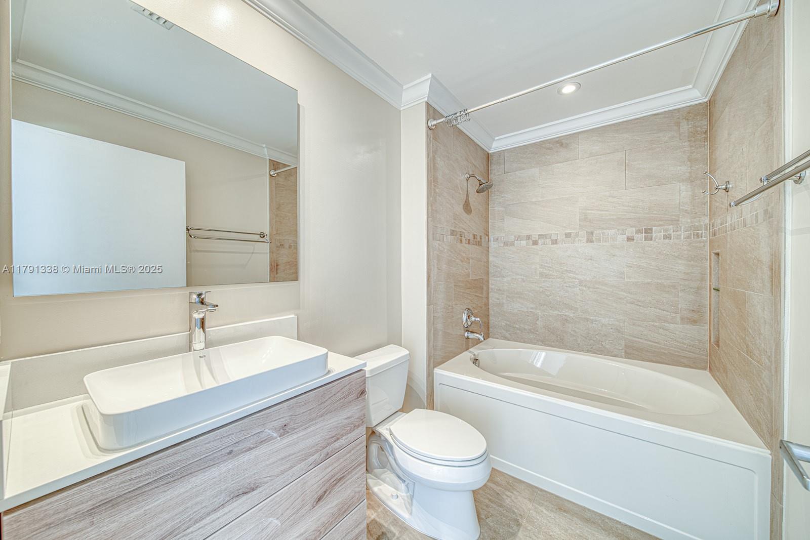 90 Alton Road, Unit TH2 Miami Beach, FL 33139 - Photo 21 of 32 a bathroom with a sink a toilet and a bathtub