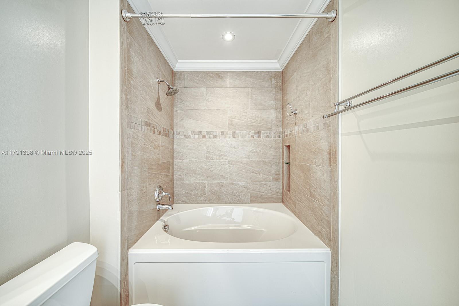 90 Alton Road, Unit TH2 Miami Beach, FL 33139 - Photo 22 of 32 a bathroom with a tub and a shower