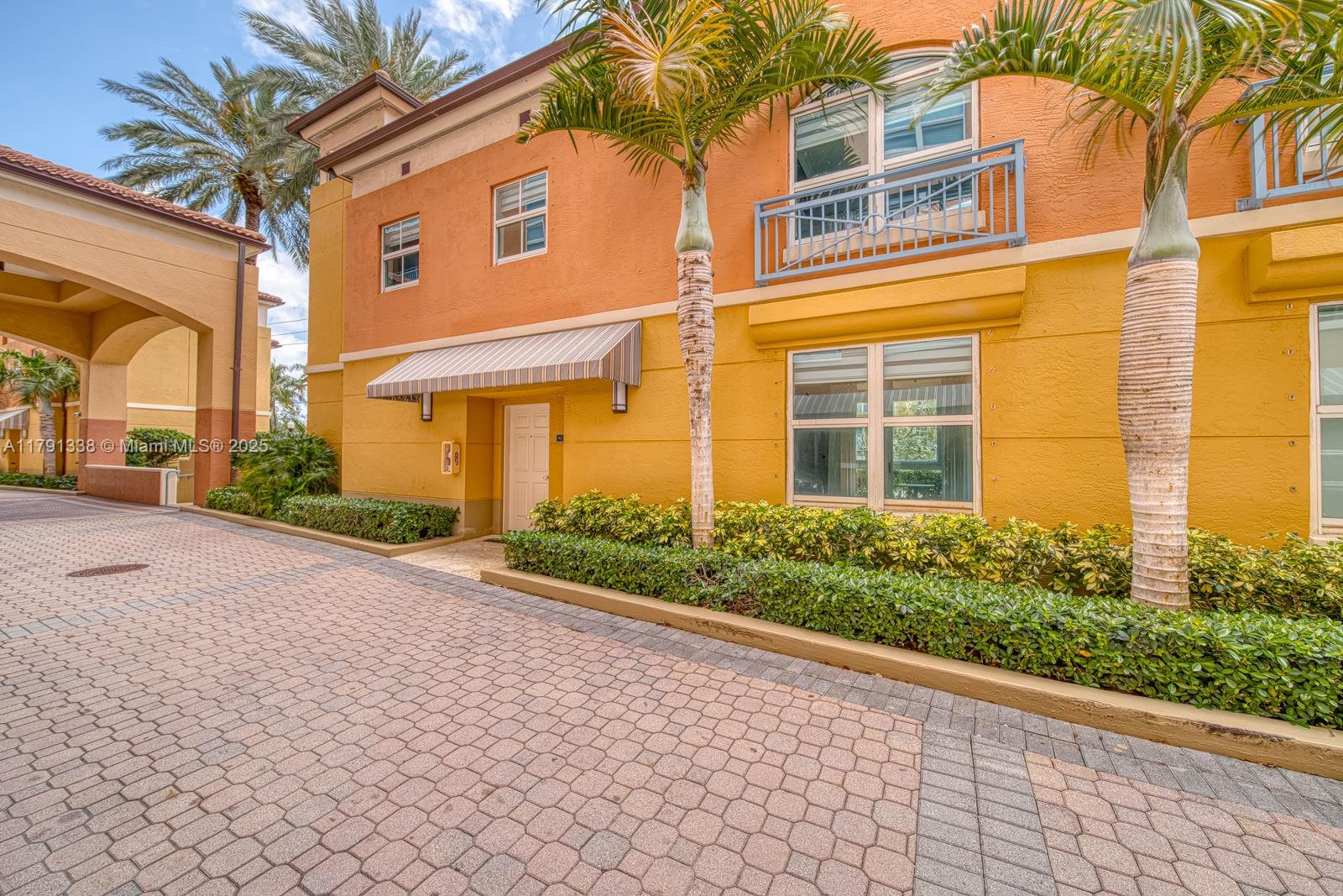 90 Alton Road, Unit TH2 Miami Beach, FL 33139 - Photo 29 of 32 front view of a brick house with a yard