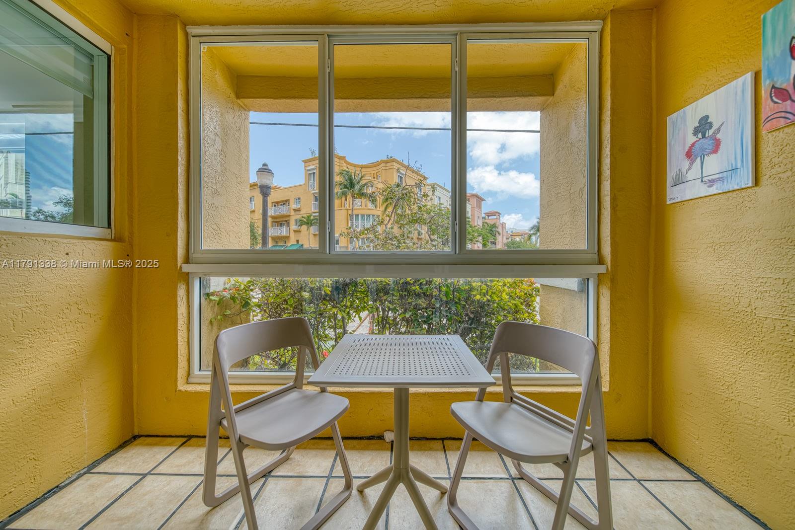 90 Alton Road, Unit TH2 Miami Beach, FL 33139 - Photo 5 of 32 a view of a dining room with furniture and window