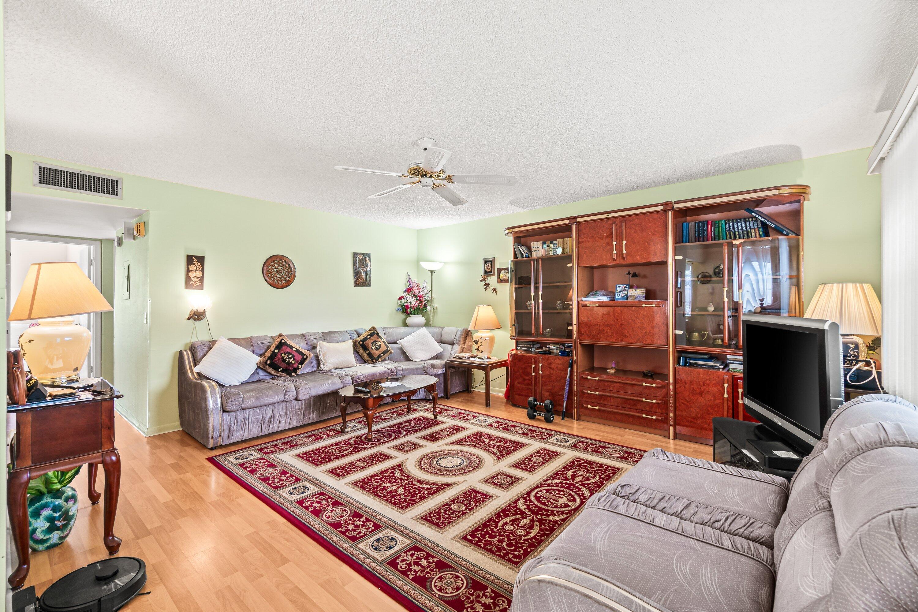 508 Normandy Lane, Unit 508 Delray Beach, FL 33484 - Photo 5 of 25 a living room with furniture and a flat screen tv