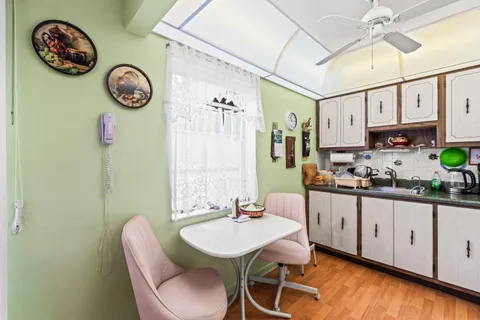 a view of a kitchen with table and chairs