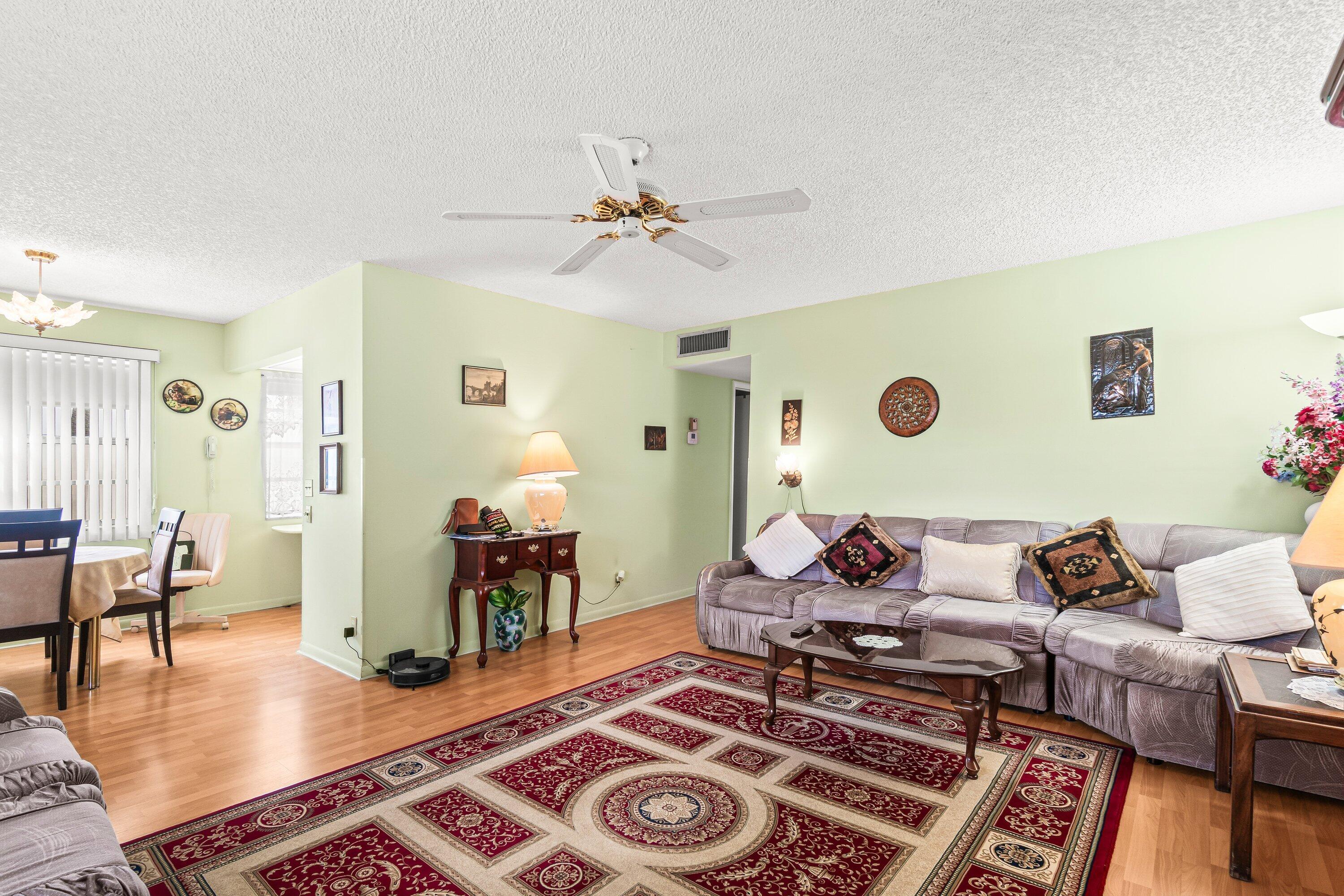 508 Normandy Lane, Unit 508 Delray Beach, FL 33484 - Photo 9 of 25 a living room with furniture and wooden floor