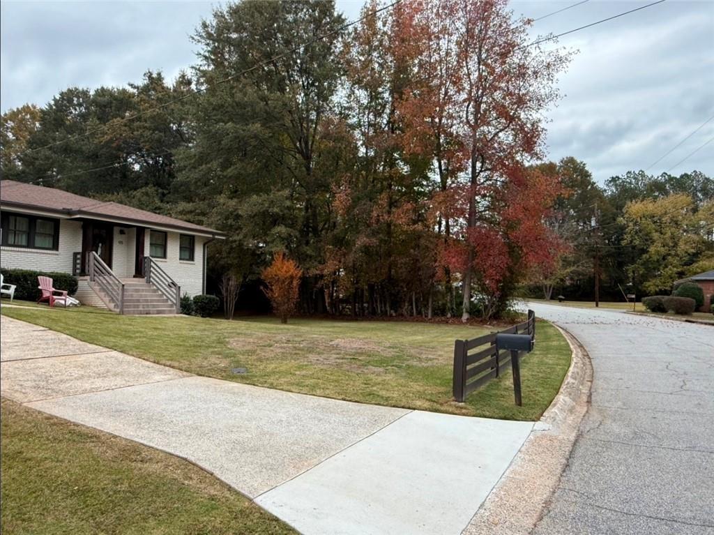 911 Lake Court Smyrna, GA 30082 - Photo 2 of 9 a view of a house with swimming pool and a yard