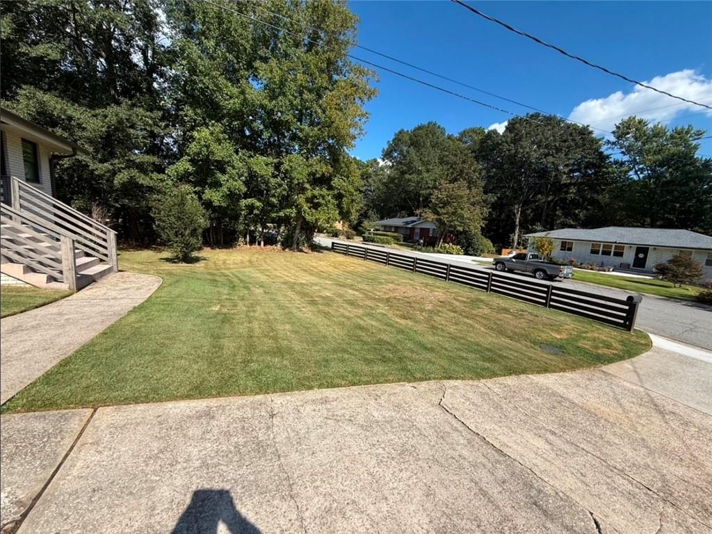 911 Lake Court Smyrna, GA 30082 - Photo 3 of 9 a view of a swimming pool with a yard