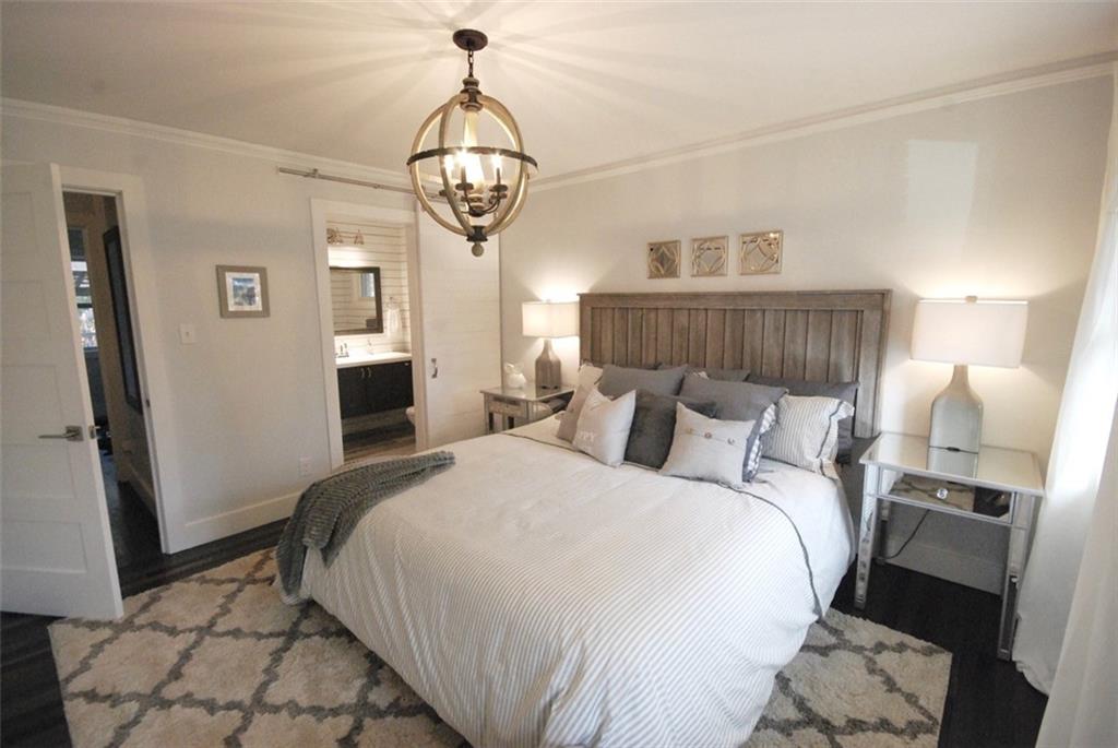 911 Lake Court Smyrna, GA 30082 - Photo 5 of 9 a bedroom with a bed and wooden floor