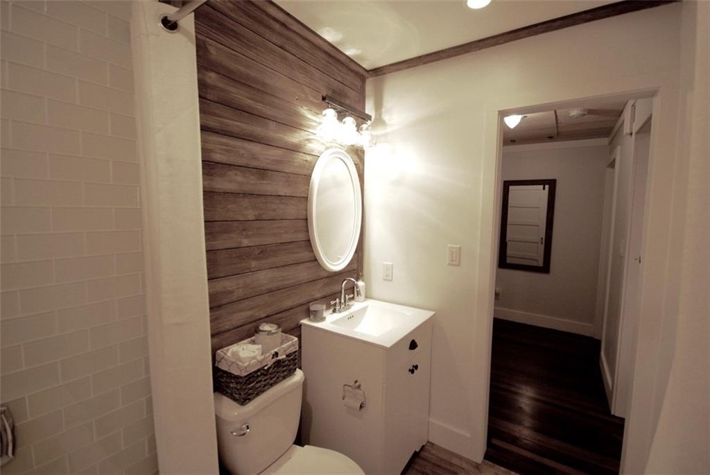 911 Lake Court Smyrna, GA 30082 - Photo 9 of 9 a bathroom with a toilet a sink and mirror