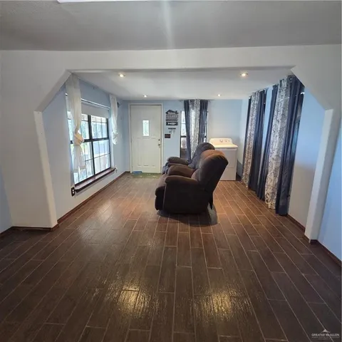 a view of kitchen with cabinets and wooden floor