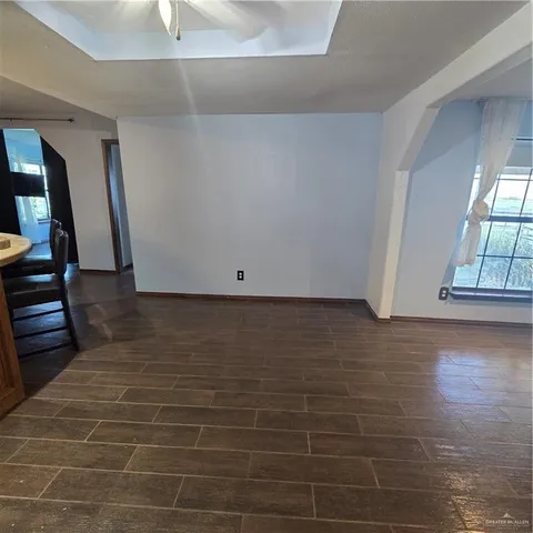 a kitchen with a table chairs refrigerator and wooden cabinets