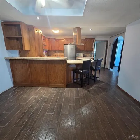 a kitchen with stainless steel appliances granite countertop a sink a stove and a refrigerator