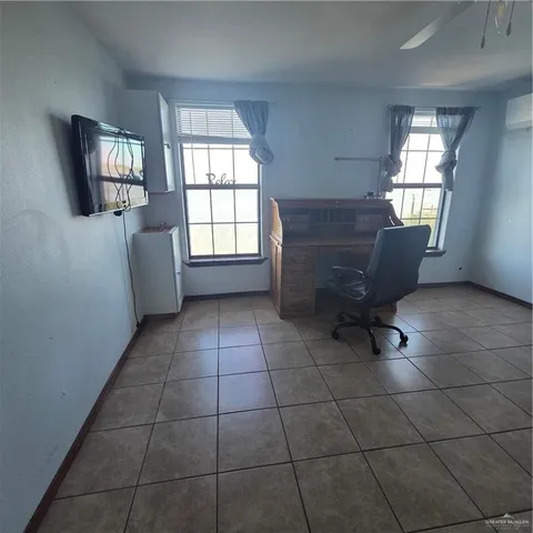 a view of workspace with window and bathroom