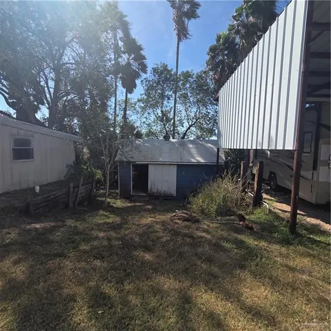a view of a backyard with a tree