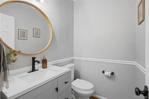 a bathroom with a sink a toilet and mirror