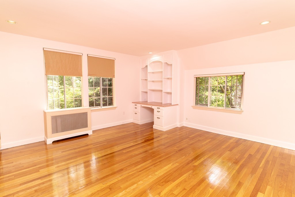 9 Penniman Road Brookline, MA 02445 - Photo 10 of 17 a view of an empty room with a window and wooden floor