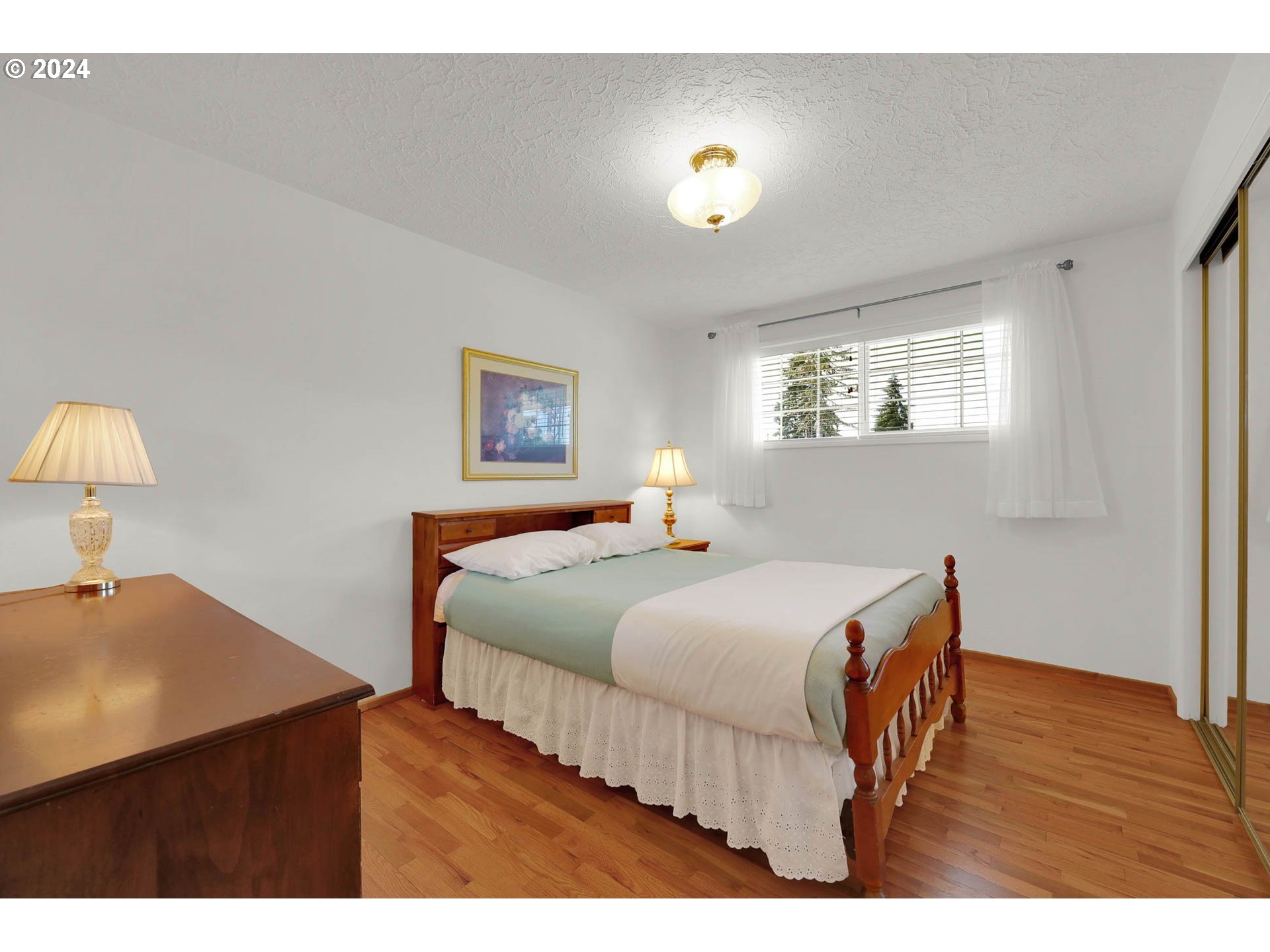 2411 15th Street Springfield, OR 97477 - Photo 7 of 18 a bedroom with a bed and a lamp