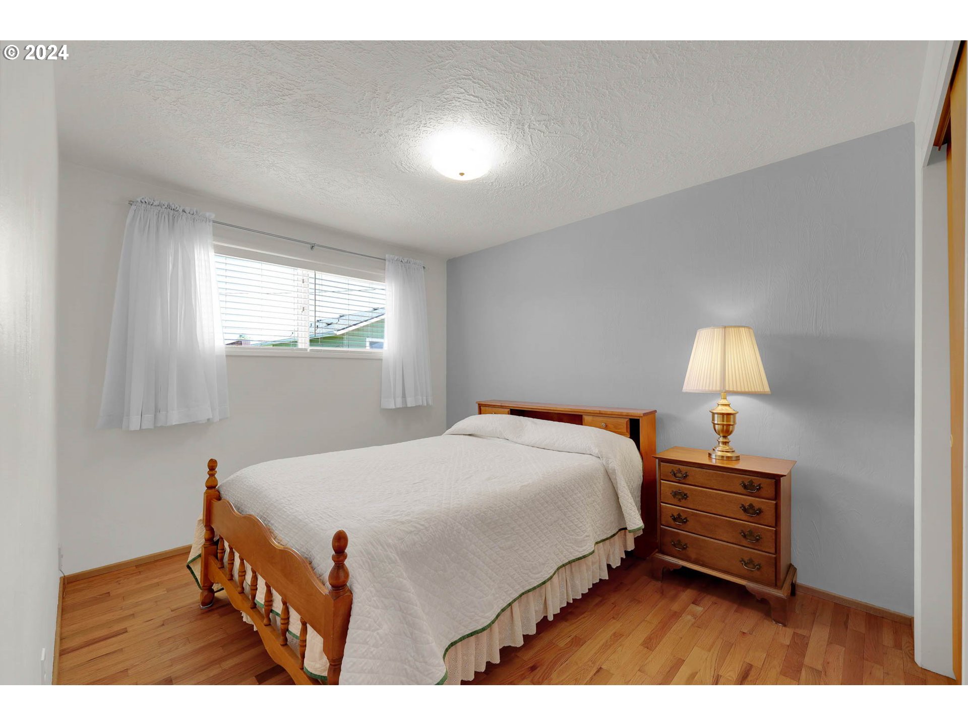 2411 15th Street Springfield, OR 97477 - Photo 9 of 18 a bedroom with a bed and a lamp