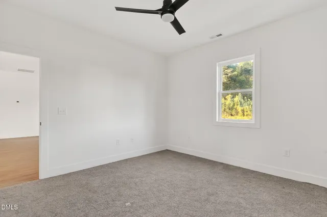 a kitchen with stainless steel appliances granite countertop a sink a stove a refrigerator cabinets and a window