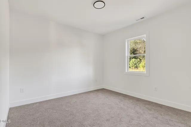 an empty room with closet area