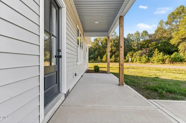 a view of a house with backyard and porch