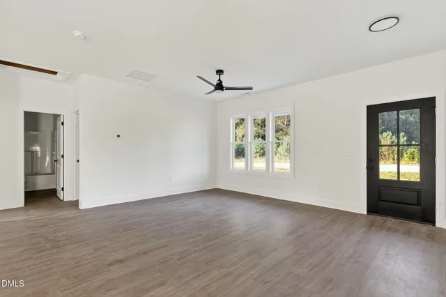 a view of kitchen with wooden floor electronic appliances and window