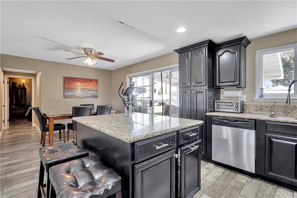 23682 Cavanaugh Road Lake Forest, CA 92630 - Photo 17 of 51 a kitchen with a stove a sink a dining table and chairs