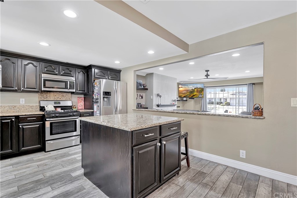 23682 Cavanaugh Road Lake Forest, CA 92630 - Photo 22 of 51 a kitchen with stainless steel appliances granite countertop a stove top oven a sink dishwasher and a refrigerator