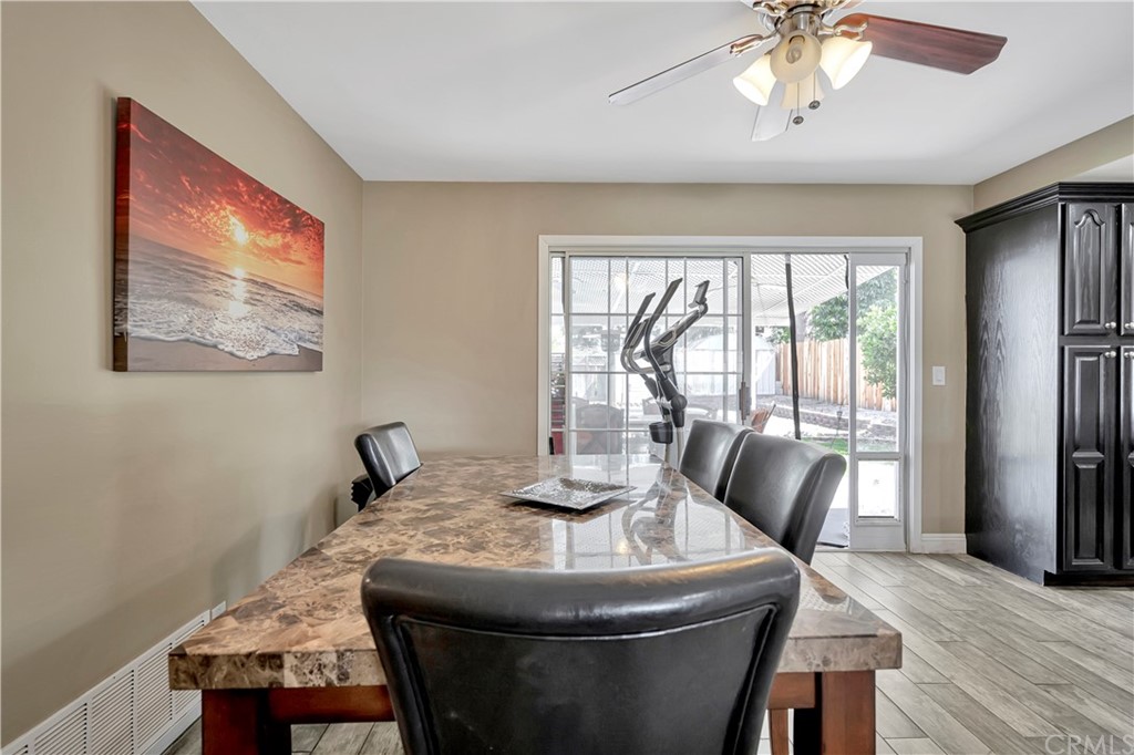 23682 Cavanaugh Road Lake Forest, CA 92630 - Photo 26 of 51 a dining room with furniture a rug and wooden floor