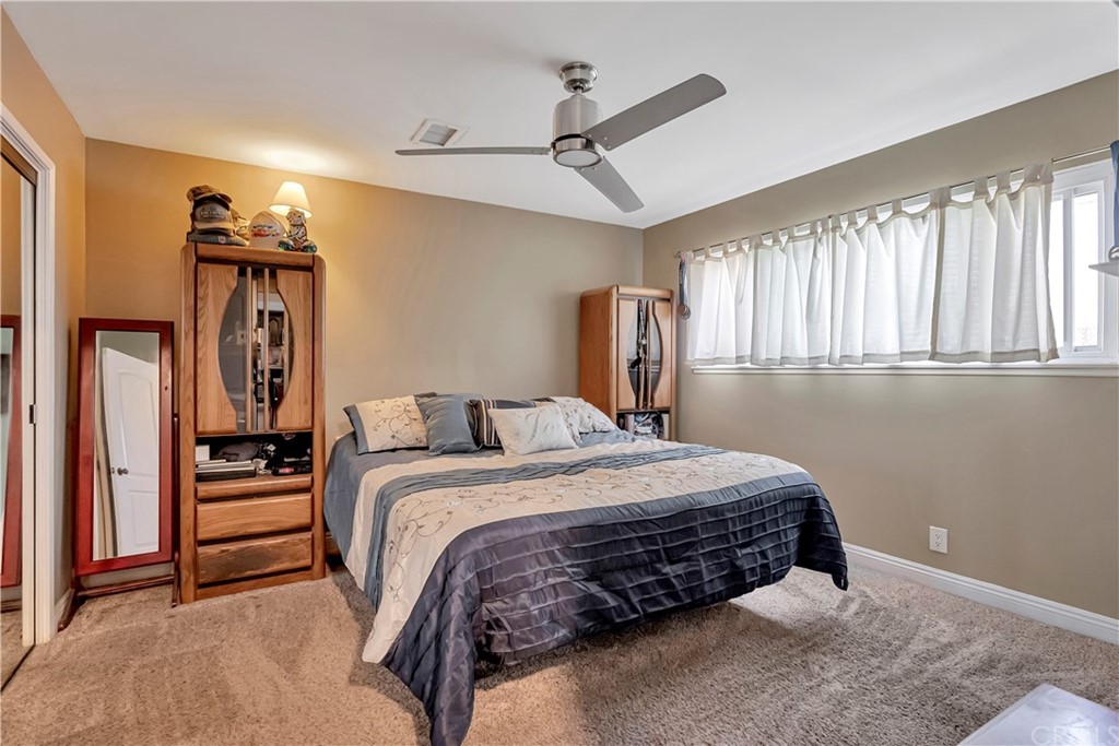 23682 Cavanaugh Road Lake Forest, CA 92630 - Photo 29 of 51 a bedroom with a bed and a chandelier