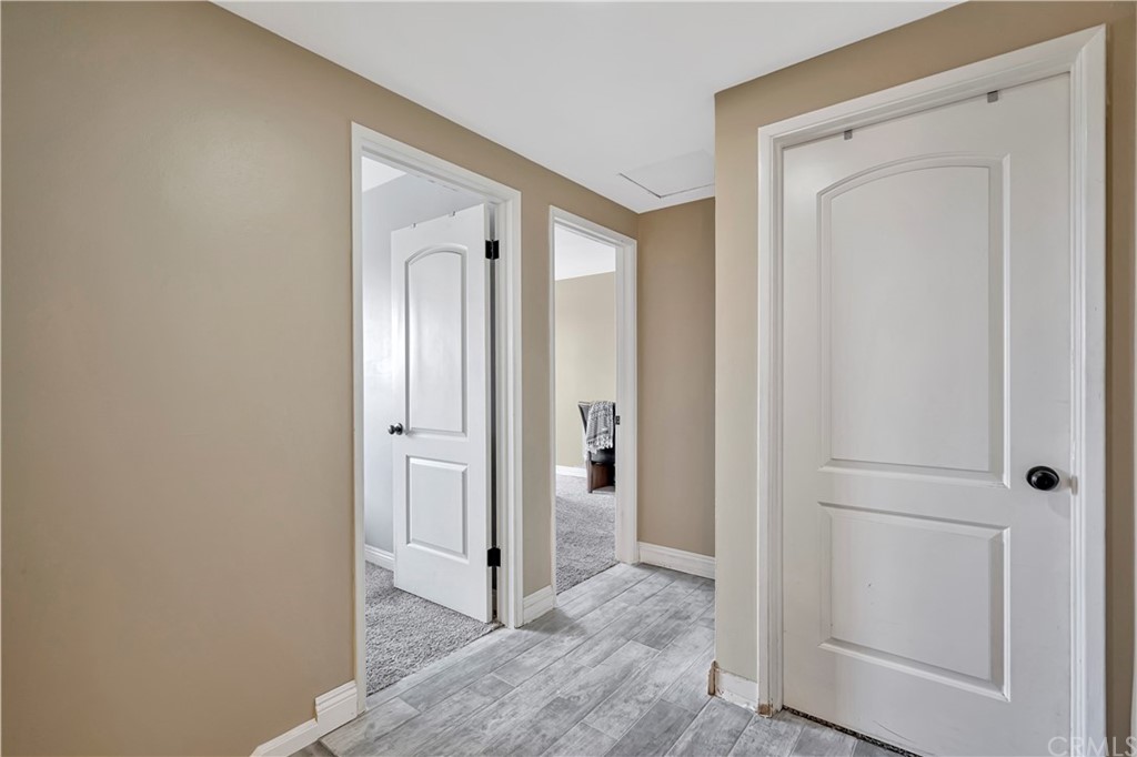 23682 Cavanaugh Road Lake Forest, CA 92630 - Photo 34 of 51 a view of a hallway with closet and wooden floor