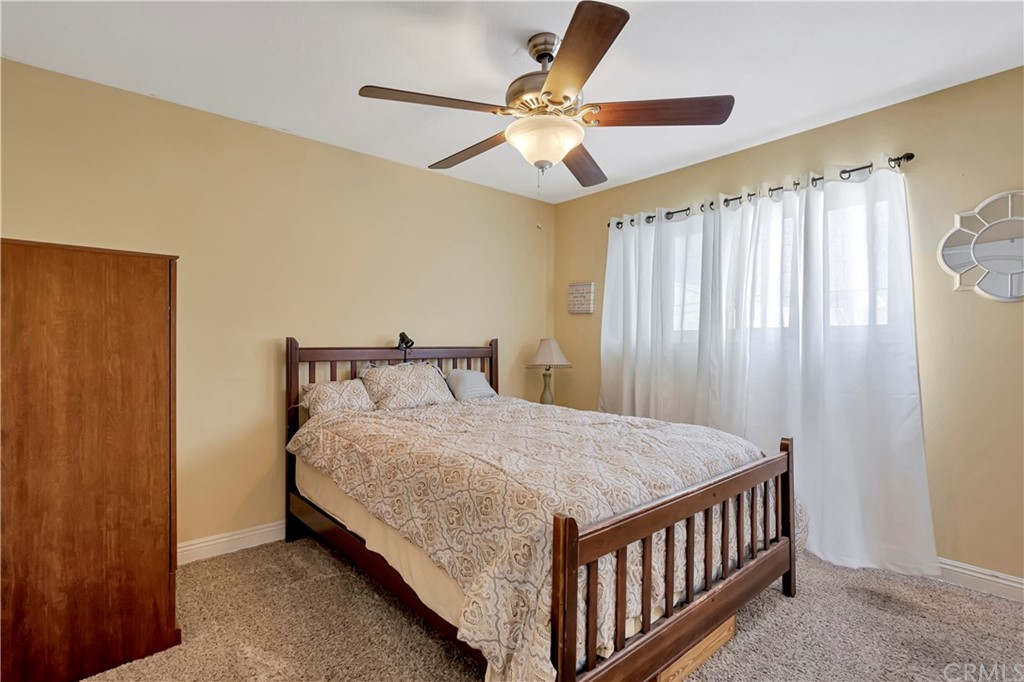 23682 Cavanaugh Road Lake Forest, CA 92630 - Photo 39 of 51 a bedroom with a bed and a chandelier