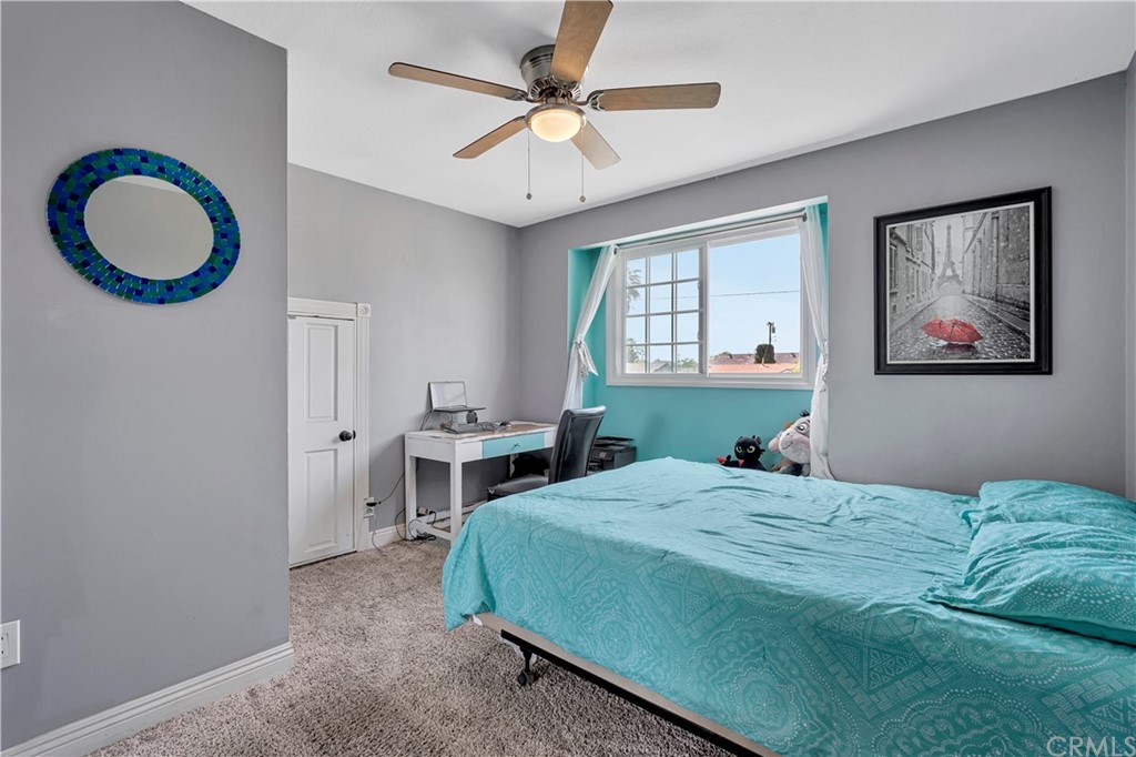 23682 Cavanaugh Road Lake Forest, CA 92630 - Photo 40 of 51 a bedroom with a bed and a chandelier