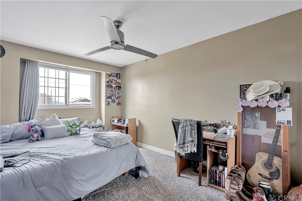 23682 Cavanaugh Road Lake Forest, CA 92630 - Photo 41 of 51 a bedroom with a bed and a chandelier