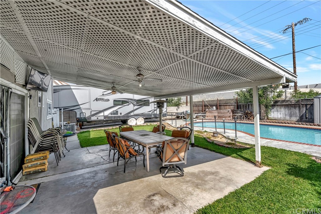 23682 Cavanaugh Road Lake Forest, CA 92630 - Photo 50 of 51 a view of a patio with table and chairs under an umbrella
