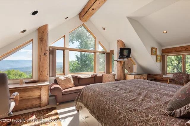 a bedroom with a large bed and a large window